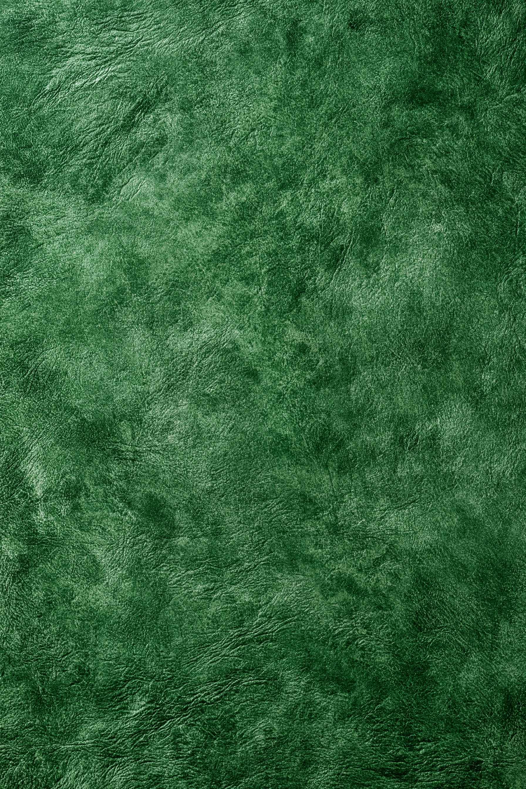 Rich forest-green hand-dyed leather surface
